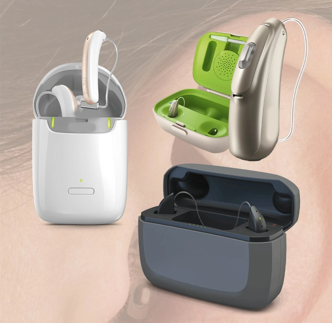 Rechargeable hearing aid case open with multiple hearing aids inside, showcasing rechargeable models from ReSound, Phonak, and Oticon.